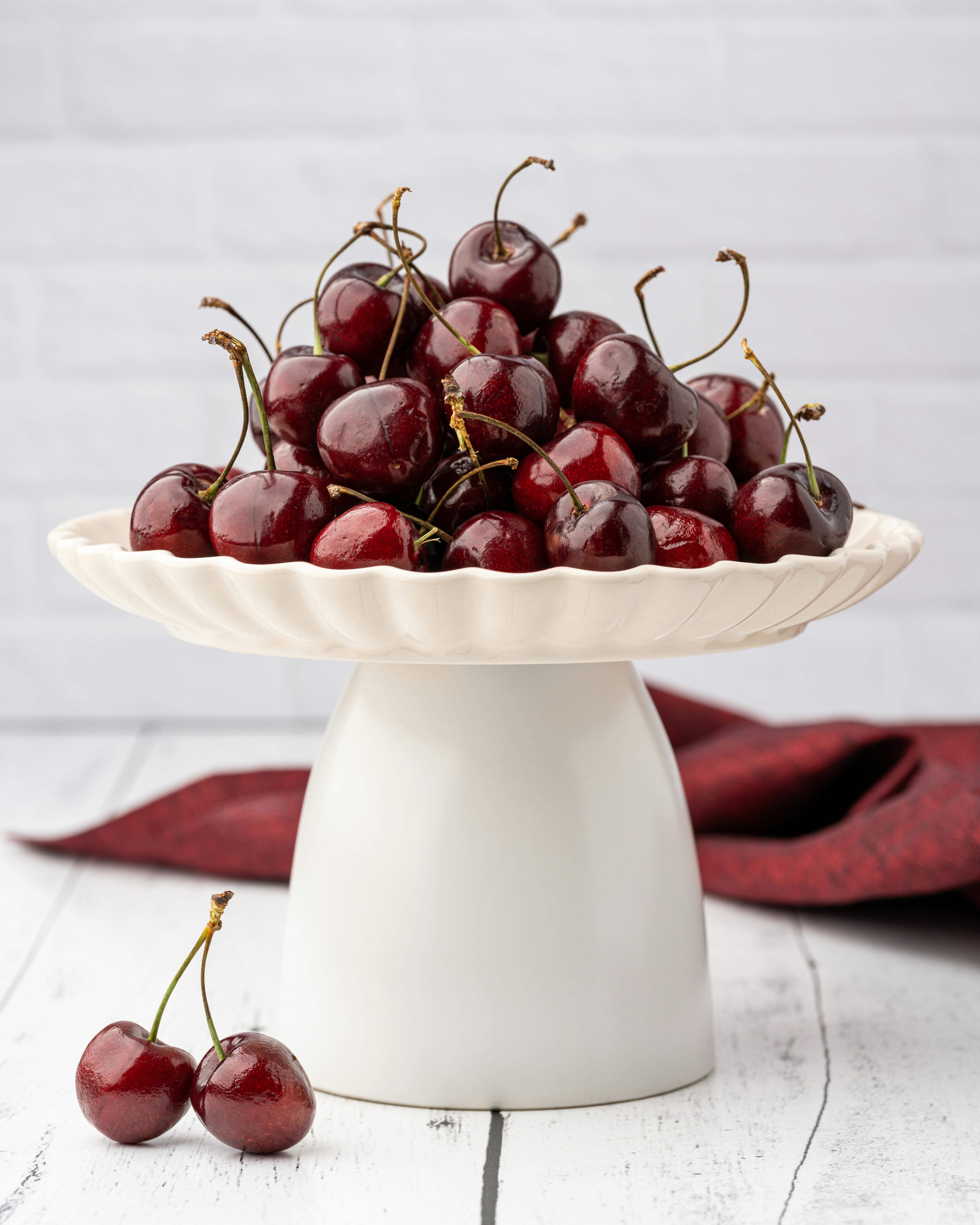 Red Cherries on White Fruit Holder · Free Stock Photo