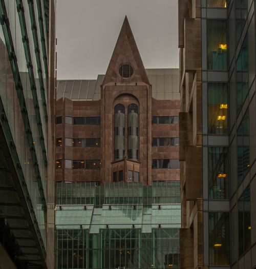 Free Striking architectural view of Minster Court against modern glass buildings in London. Stock Photo