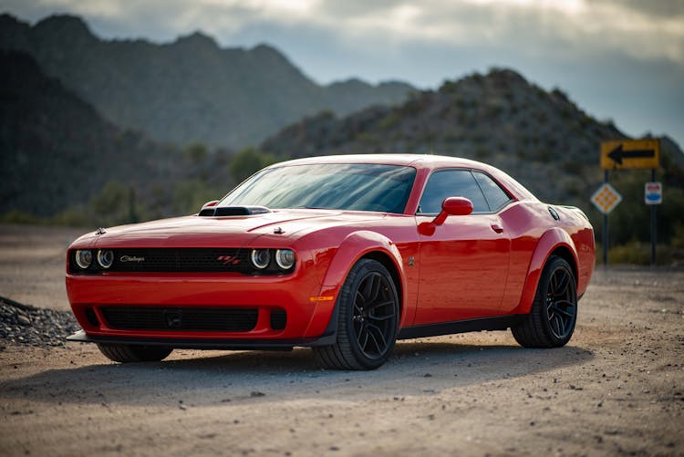 Red Dodge Challenger Parked On Unpaved Road