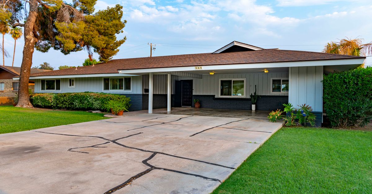 Elegant suburban bungalow with a well-manicured lawn and spacious driveway.