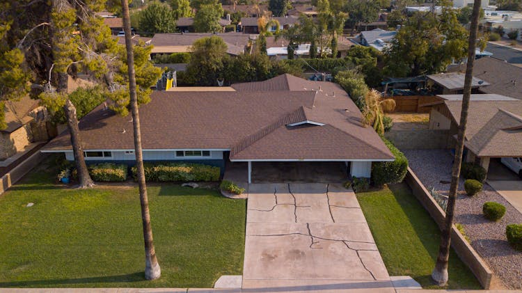 An Aerial Shot Of A House With A Driveway