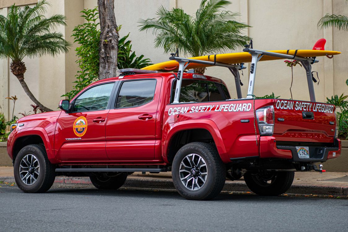 A Red Rescue Vehicle Parked Near a Building · Free Stock Photo