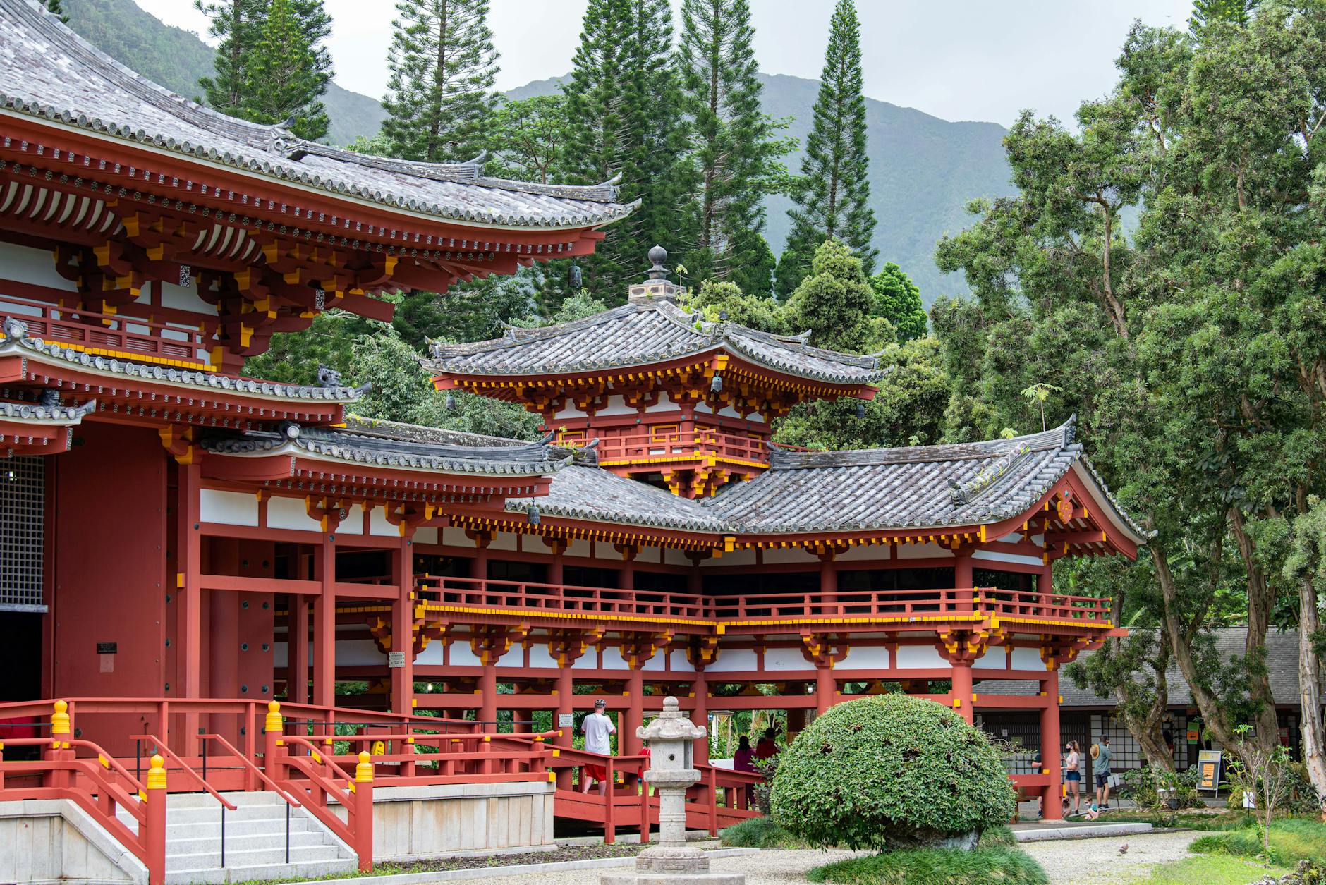 A beautifully preserved Japanese temple surrounded by lush greenery and trees.