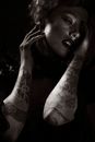 Woman with Arm Tattoos Holding his Face