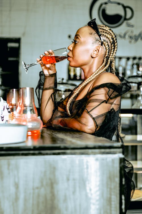 Woman with Braided Hair Drinking from a Champagne Glass