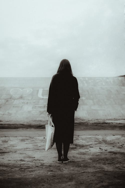 Free Black and White Photo of Woman Standing with a Shopping Bag  Stock Photo