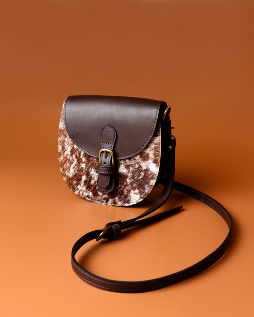 Chic leather sling bag with brown texture, perfect for stylish fashion statements. - Care and Maintenance Tips for Prolonging Handbag Life