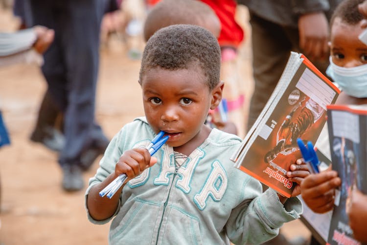 Boy Putting Pens On His Mouth