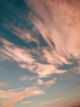 A breathtaking display of clouds at sunset, with soft pink and blue hues creating a serene atmosphere.