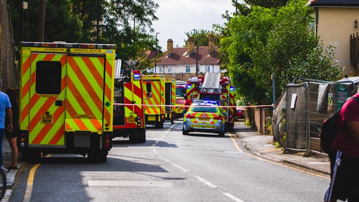 Police and firefighters responding to a car crash at night