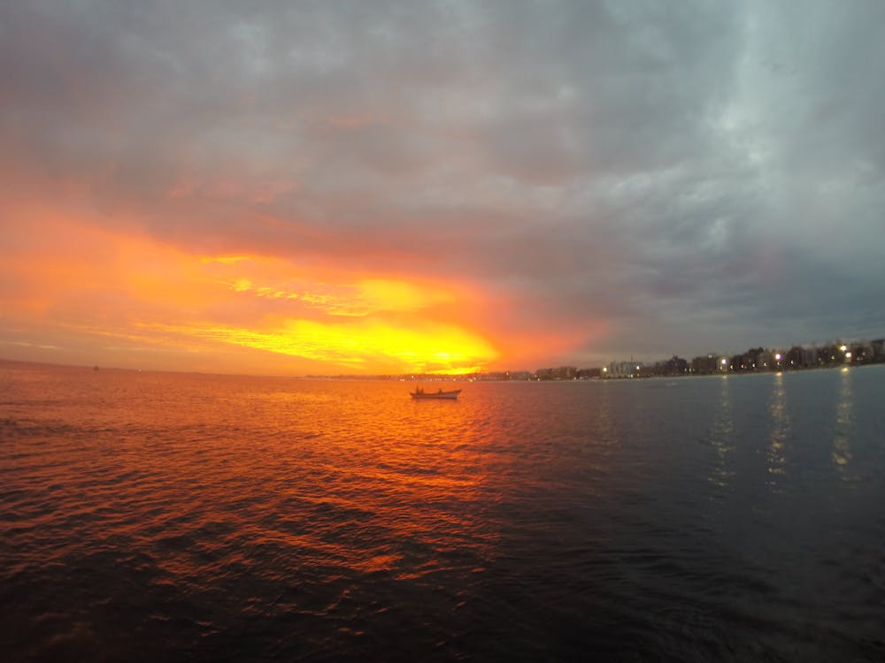 Foto profissional grátis de canoa, mar, sol