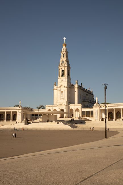 Stunning view of the Sanctuary of Fátima in Portugal with a clear sky at sunset.
