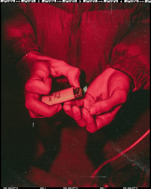 A Person Wearing Jacket Holding Lighter 