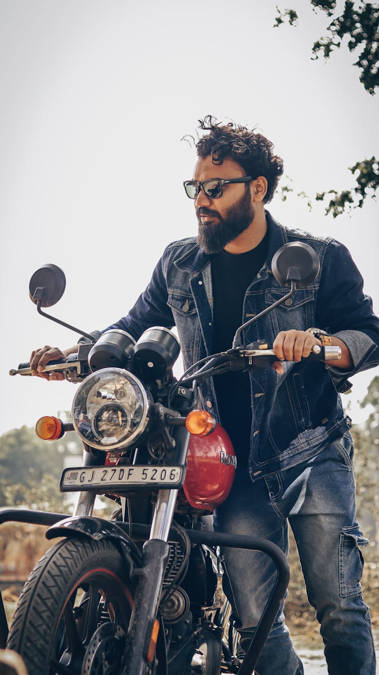 Bearded Man Holding A Motorcycle