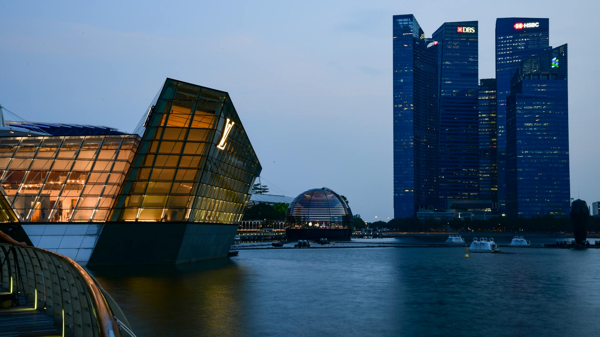 Dusk view of Marina Bay, Singapore with futuristic skyscrapers and waterfront.