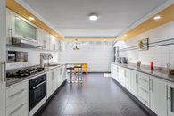 A sleek and spacious kitchen interior in Bogotá, Colombia, featuring modern design and ample lighting.