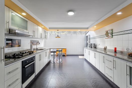 A sleek and spacious kitchen interior in Bogotá, Colombia, featuring modern design and ample lighting.