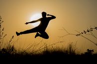 Silhouette of Man Doing Kick Jump during Sunset