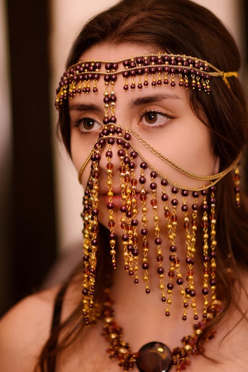 Close-up Photo of an Elegant Woman wearing Gold Headdress