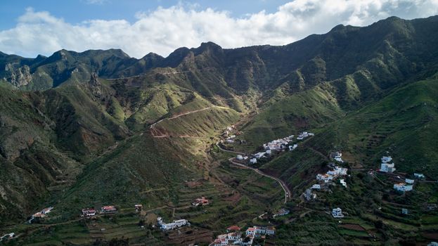 Breathtaking aerial shot of a lush mountain village landscape in Santa Cruz de Tenerife, Spain.