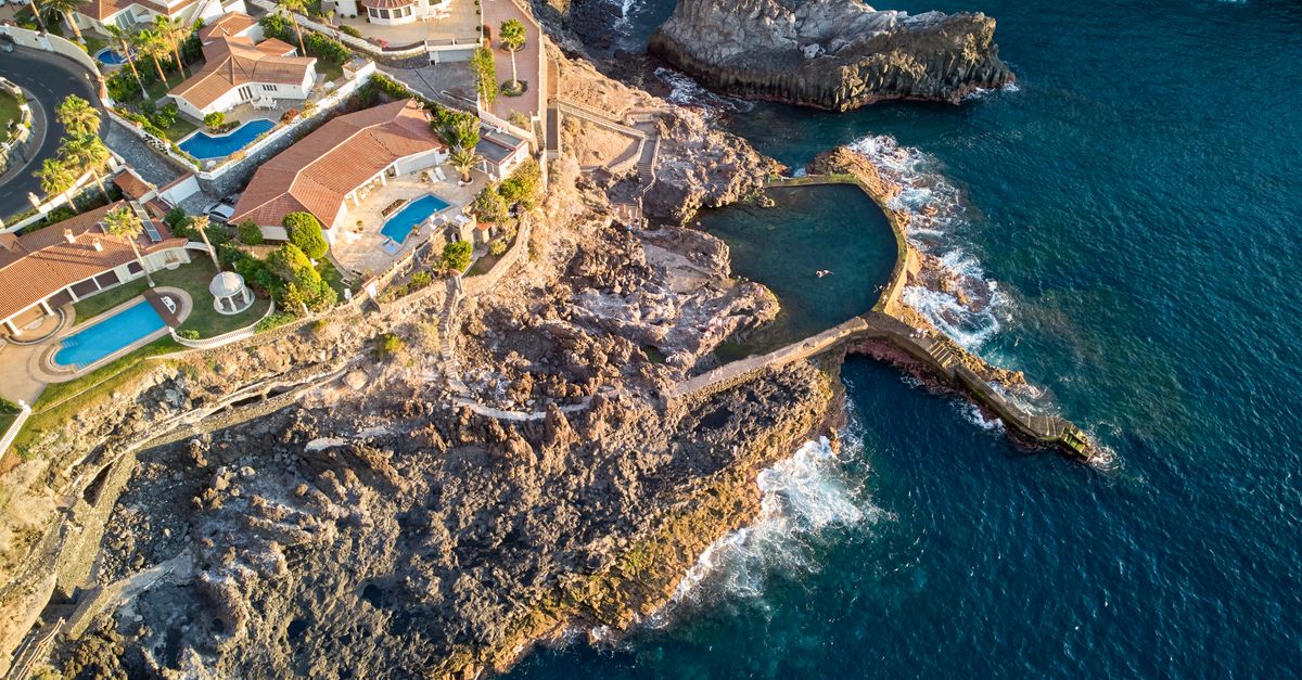 Stunning aerial view of Santiago del Teide's rocky coast and villas.