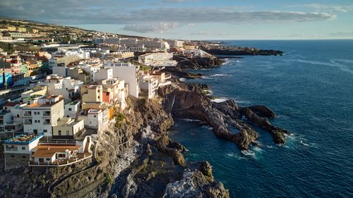 Free Scenic aerial view of Santiago del Teide’s coastal town and rocky cliffs on a sunny day. Stock Photo