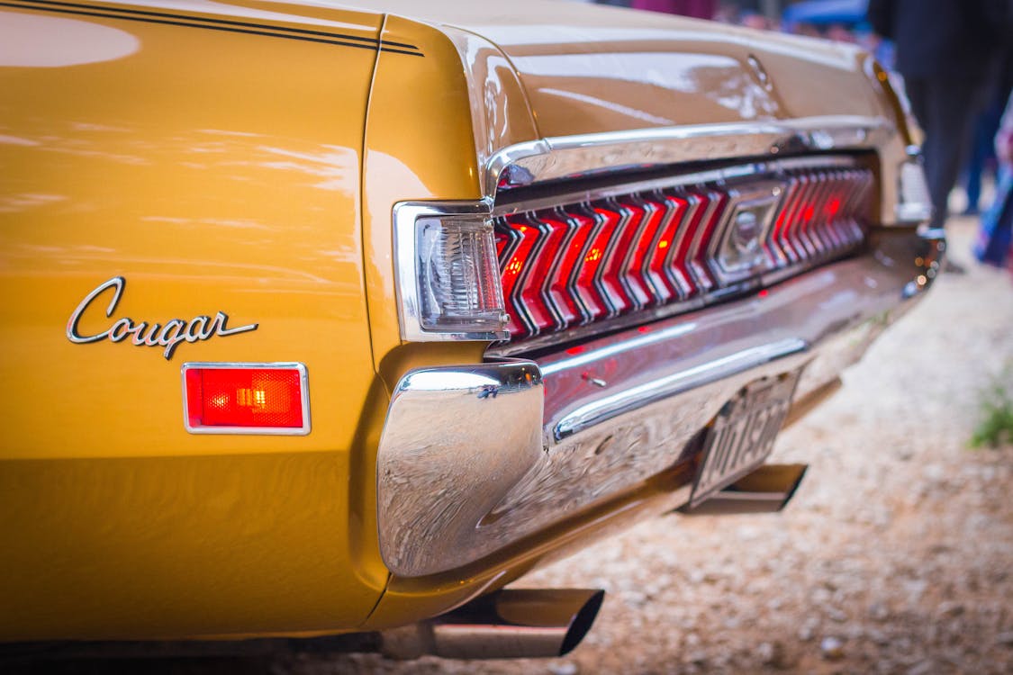 Free Close-up Photo of a Yellow Vintage Car Stock Photo