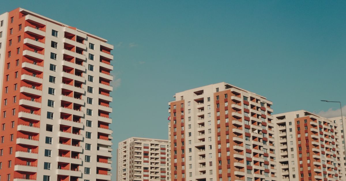 Captivating view of modern high-rise apartment buildings under a clear blue sky.