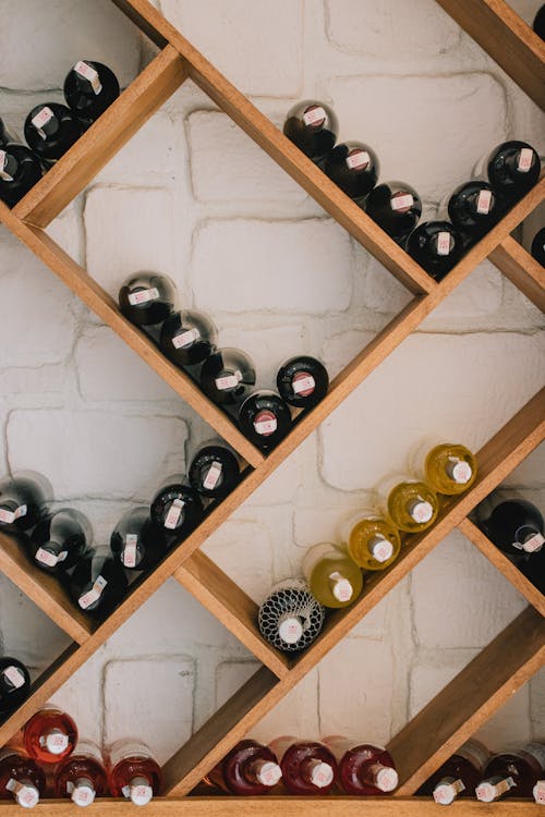 Wine Bottles on Brown Wooden Shelf