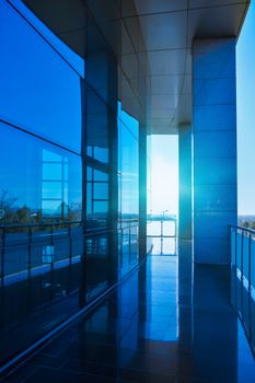 Sunlit corridor with glass panels and reflections in Edirne, Turkey.