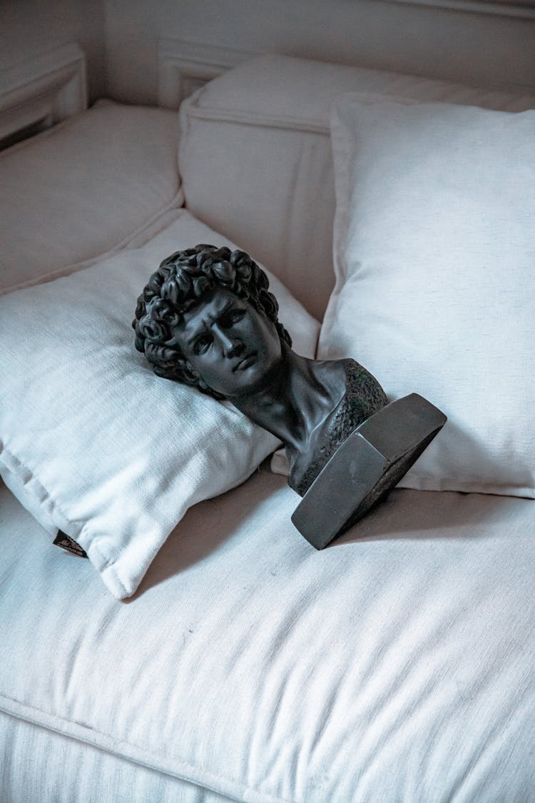 Sculpture Of Head On Sofa