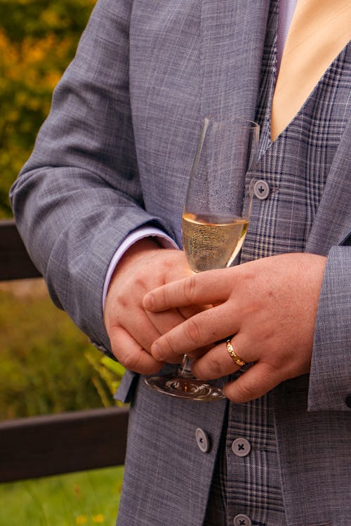 Close Up Photo of a Person Holding Champagne Glass