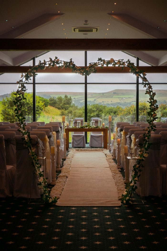 Flower-lined wedding aisle with rows of chairs