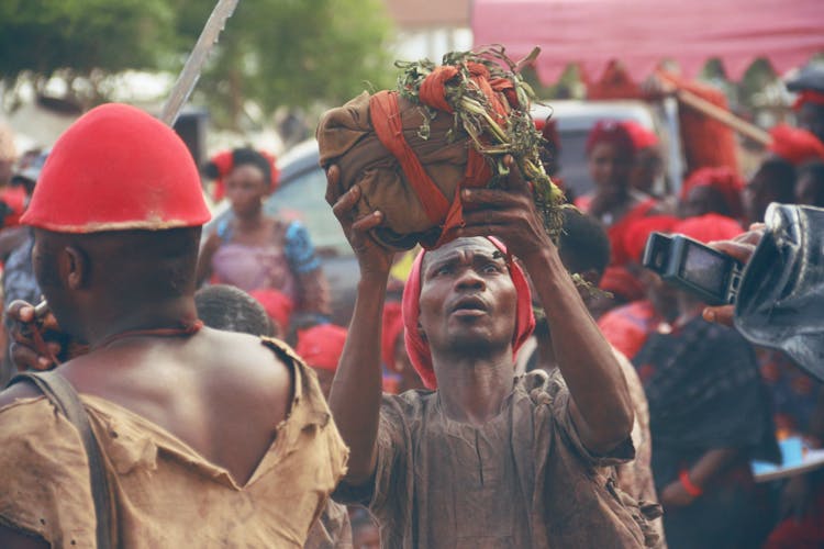 Man Holding Bundle In Crowd