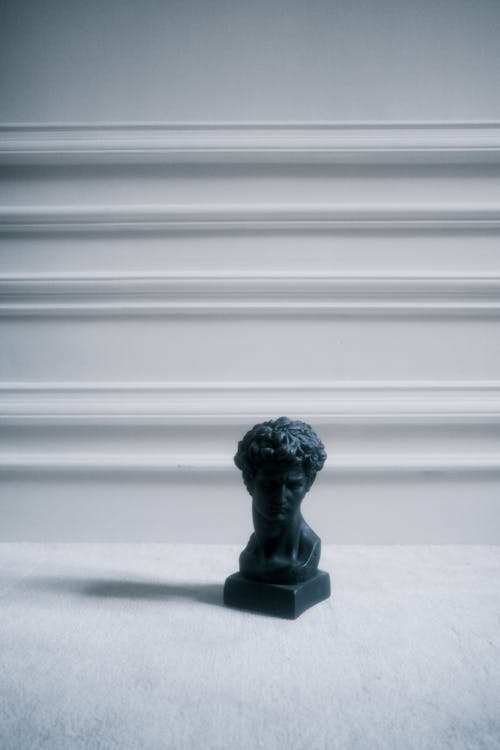 A Black Colored Sculpture of a Man's Head