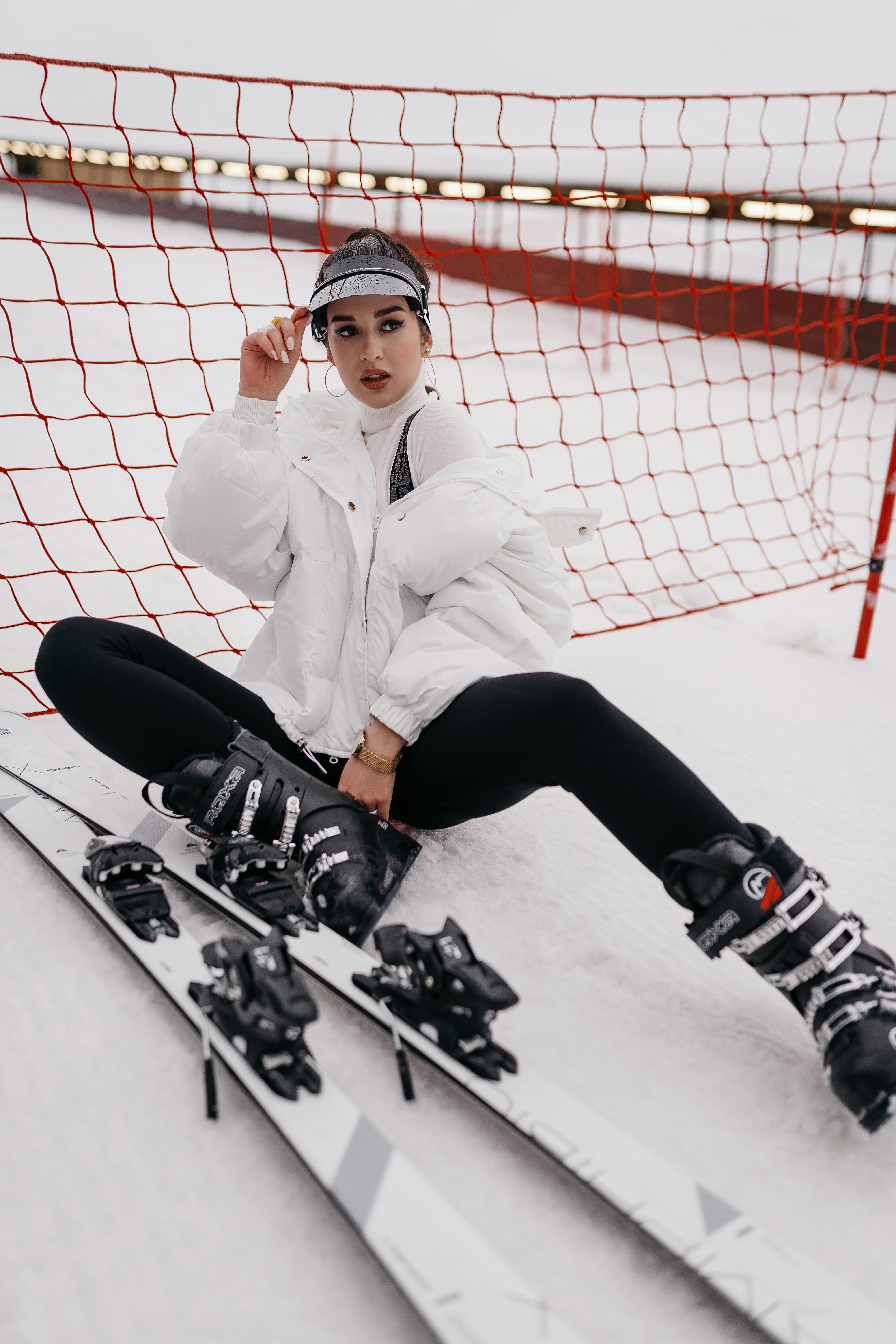 Woman zipping up fitted ski suit before skiing