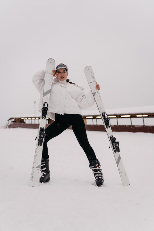 Free Woman Standing with Skis Stock Photo