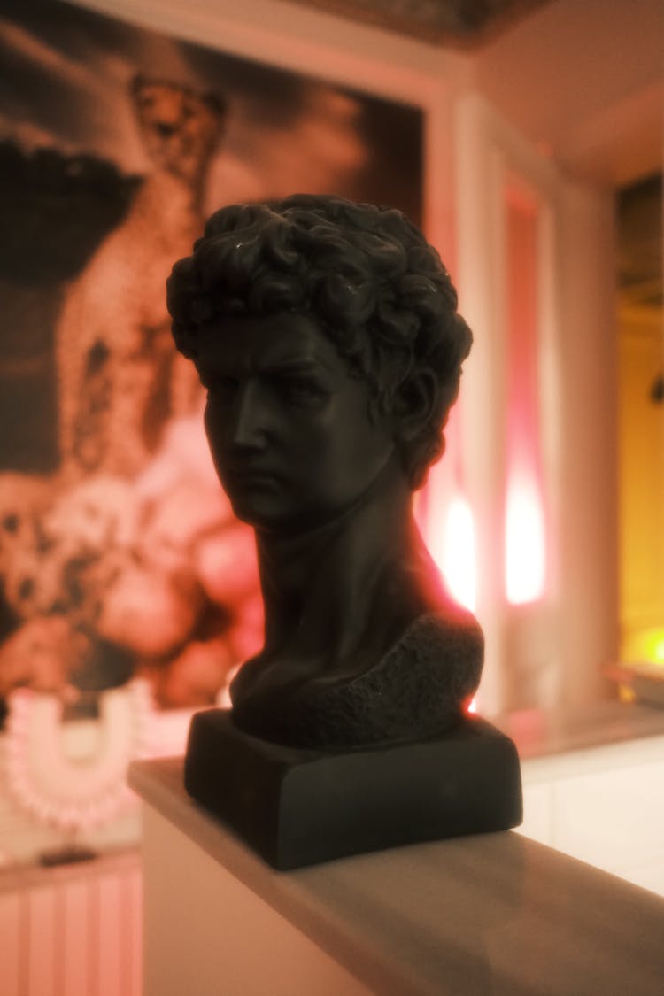 A Black Colored Sculpture Of A Man's Head