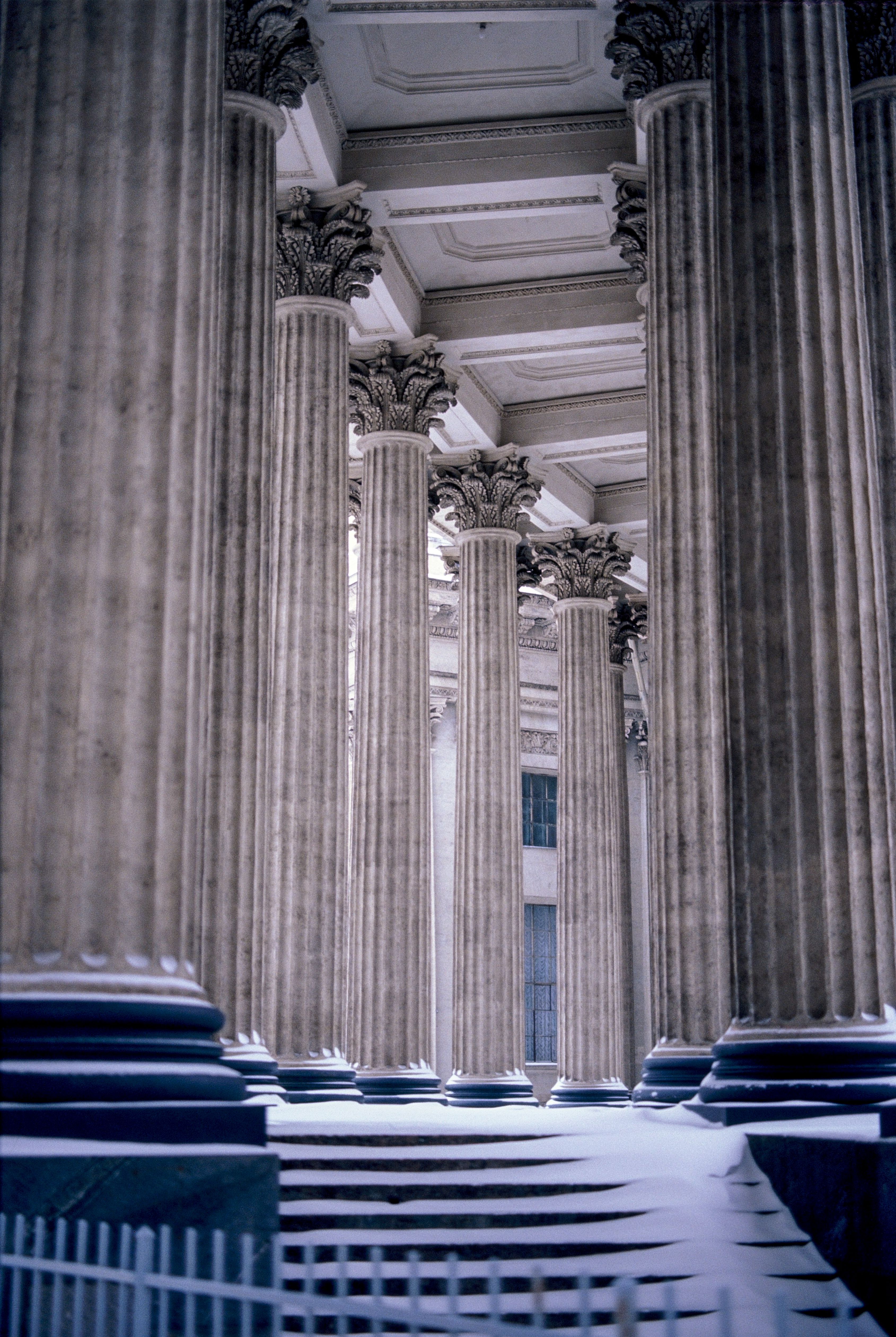 St. Petersburg columns dusted with snow, showcasing classical architecture in a wintry scene.