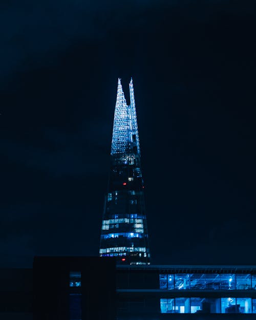 Lighted High Rise Building During Night Time