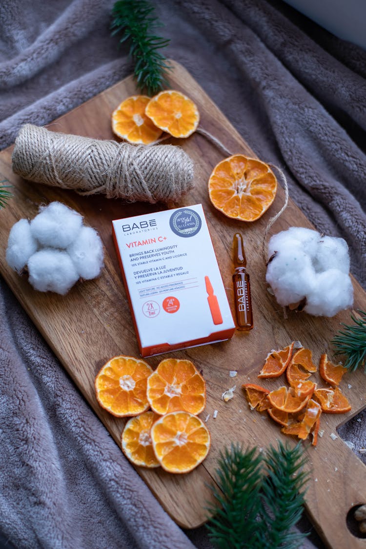 Vitamin C Ampule On A Wooden Cutting Board 