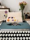 Blue Sterling Typewriter on a Table