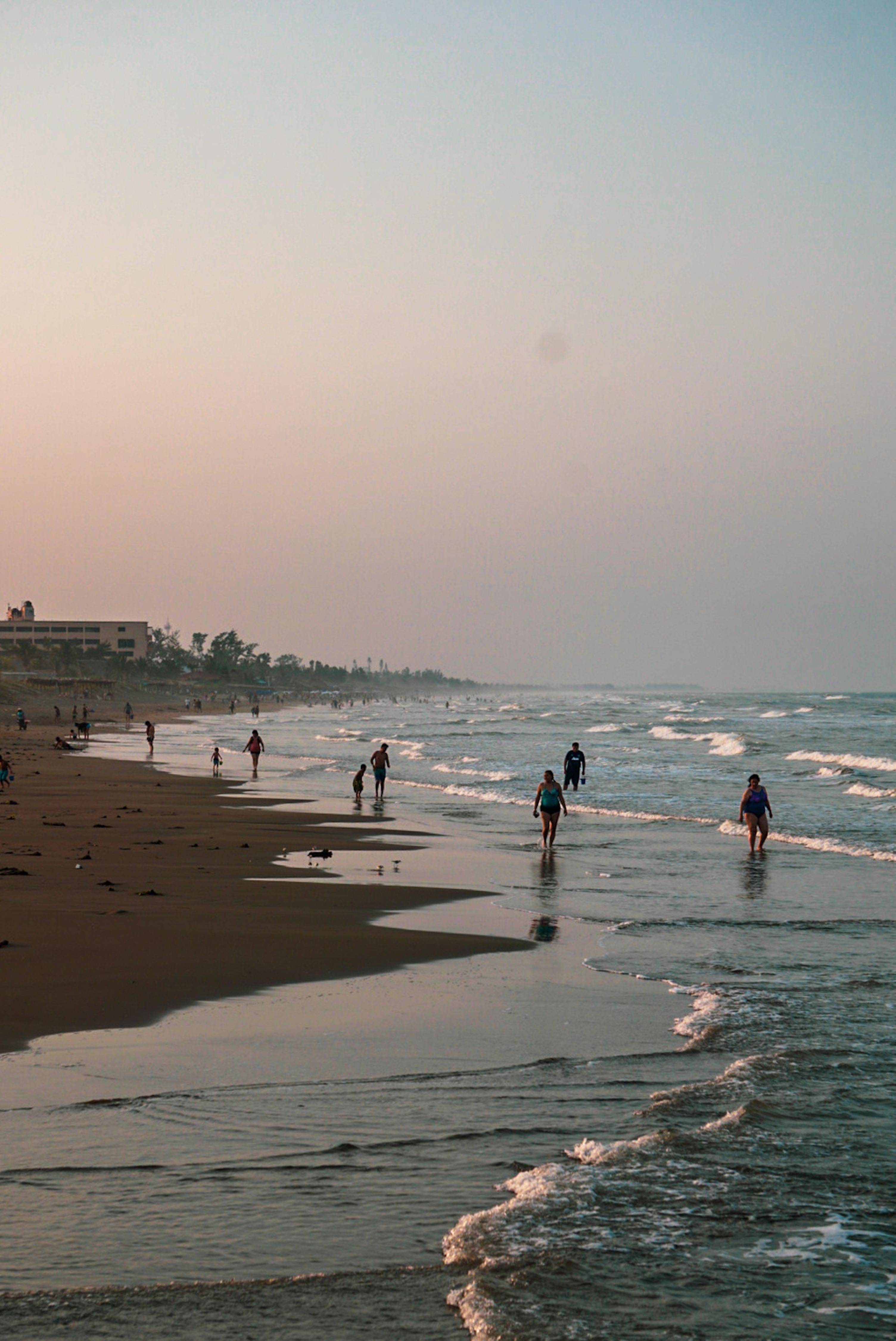 People walking on Playa de Veracruz, Mexico during a calm evening.