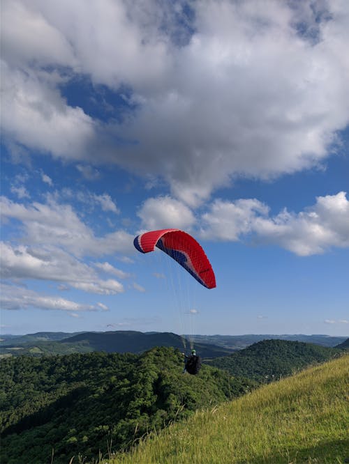 Free A Person Paragliding on the Mountain Stock Photo