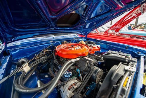 Free Close-up view of a vintage car engine with an open hood highlighting mechanical details. Stock Photo