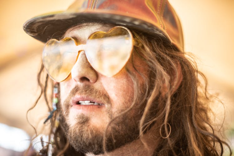 Close-up Of Man Wearing Heart Shaped Sunglasses 