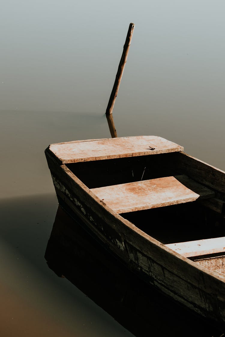 Wooden Boat Anchored On Body Of Water