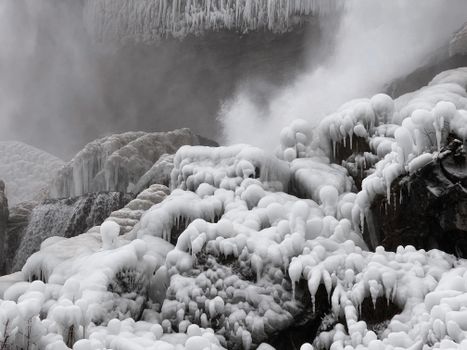 Breathtaking view of ice formations at Niagara Falls during winter, showcasing frozen beauty.