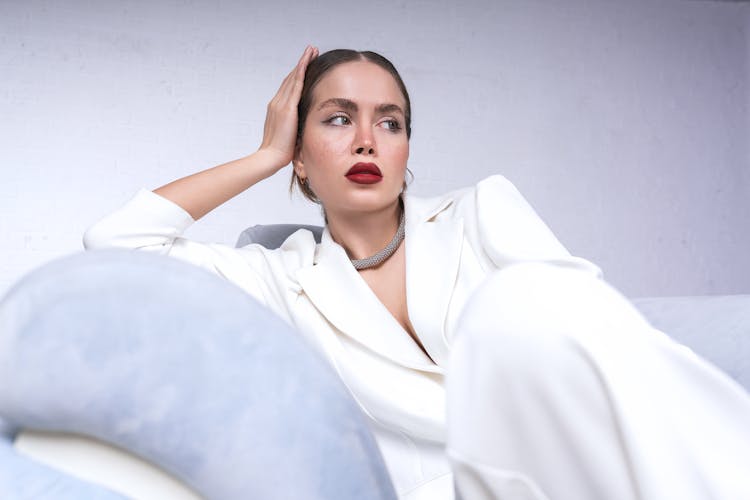 A Woman In A White Blazer Looking Away