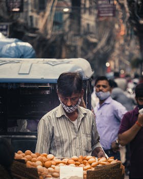 A bustling street scene of a vendor selling eggs in a New Delhi marketplace.